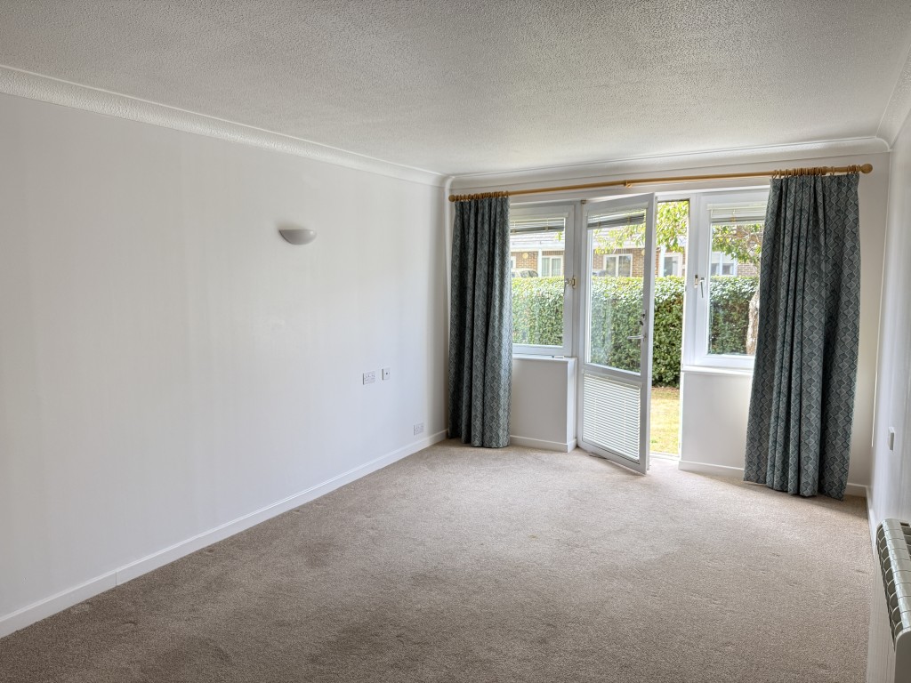 Lot: 96 - GROUND FLOOR ONE-BEDROOM RETIREMENT FLAT - Living room with view out of rear door